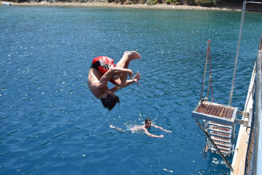 boy-jumping-of-gulet-boat-turkey